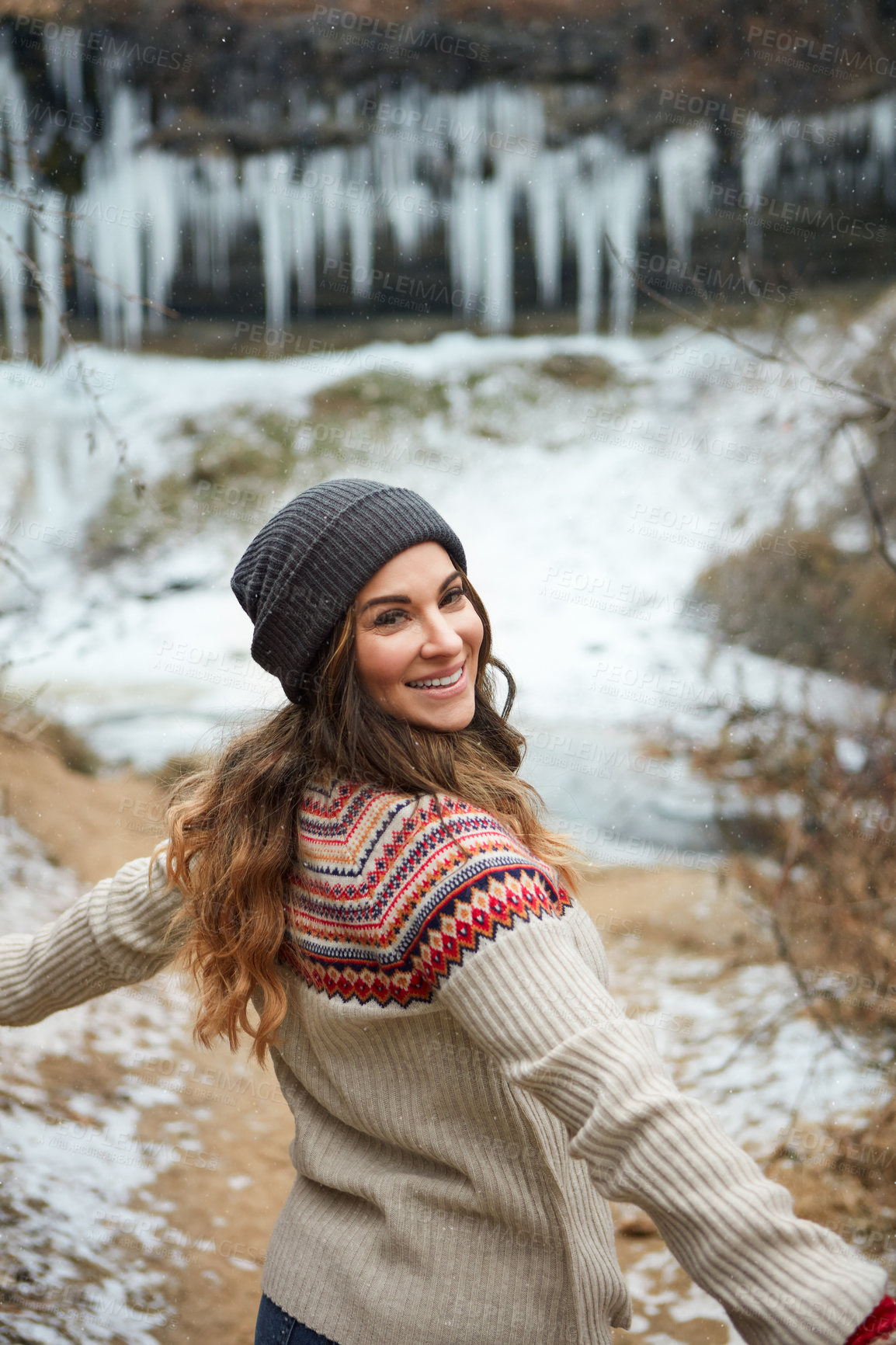 Buy stock photo Rearview portrait of an attractive young woman spending the day outside during winter
