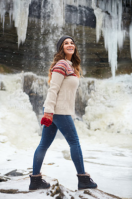 Buy stock photo Full length shot of an attractive young woman spending the day outside during winter