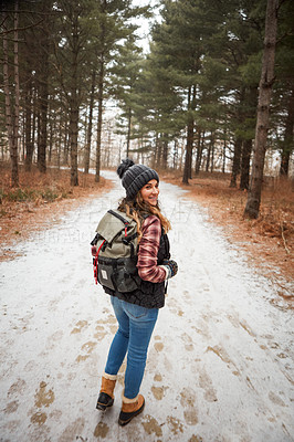 Buy stock photo Portrait of a young woman hiking in the wilderness during winter