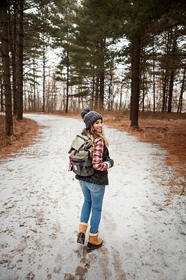 Buy stock photo Portrait of a young woman hiking in the wilderness during winter