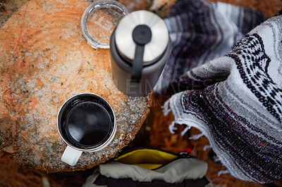Buy stock photo High angle shot of a mug filled with coffee alongside a flask on a tree stump in the wilderness