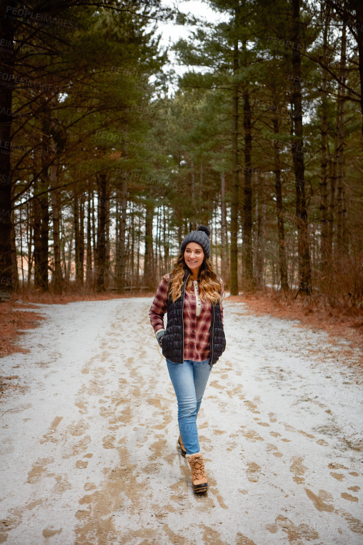 Buy stock photo Shot of a young woman hiking in the wilderness during winter