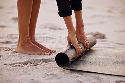 Buy stock photo Woman, yoga and beach with hand and feet for rolling mat with clean wellness or fitness. Female person, meditation and yogi on seashore with hands in the outdoor for start in the morning and pilates.