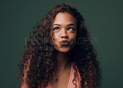 Buy stock photo Cross, eyes and funny girl in studio with playful mood, joke or unique, quirky and fun personality on green background.  Comic, emoji and face with prank gesture, expression or crazy character 