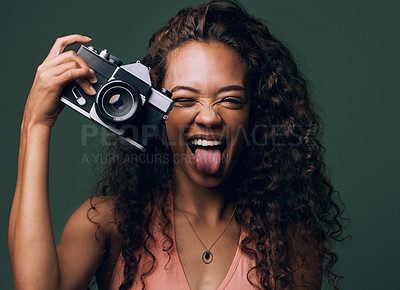Buy stock photo Woman, camera and excited with photography in studio on green background for fun, art and creativity. Photographer, fashion and lenses for memories as hobby with smile, happiness and funny as artist