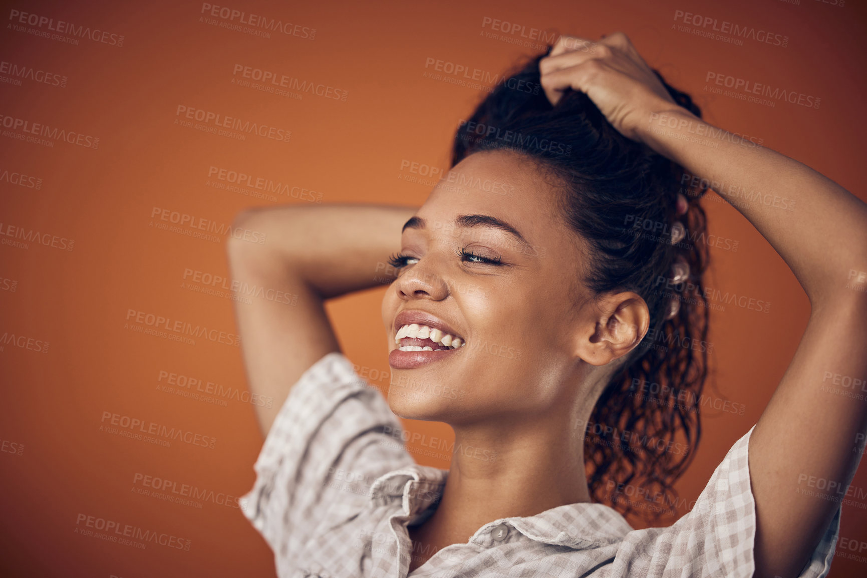 Buy stock photo Washing, smile and woman with wet hair in studio with cosmetics, shampoo or treatment on orange background. Haircare, model and scalp detox with growth, texture or cleaning, serum or gel application