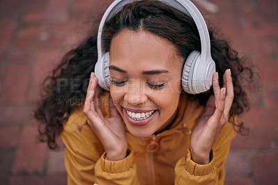 Buy stock photo Girl, headphones and listening to music outdoor with inspirational, wellness and mental health podcast. Happy young person thinking in top view with audio tech or electronics for subscription in city