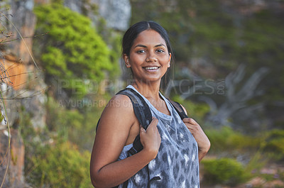 Buy stock photo Shot of a young woman enjoying a sunset hike on a mountain range outdoors