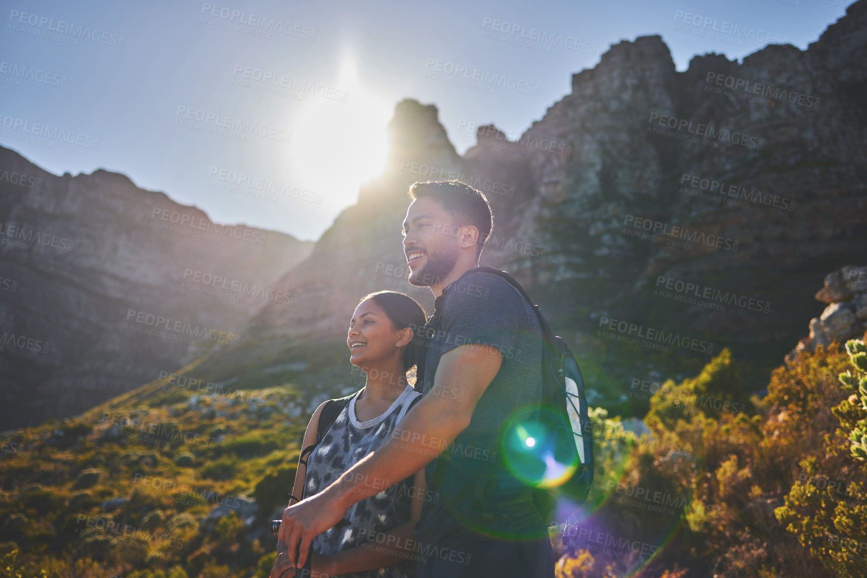 Buy stock photo Shot of a young couple hiking on a mountain range outdoors