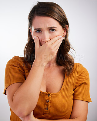 Buy stock photo Woman, portrait and shocked with bad news, secret or scary story on a gray studio background. Female person with hand on mouth in shock, OMG or wtf for alert, surprise rumor or gasp from announcement