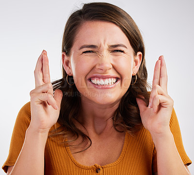 Buy stock photo Studio shot of a young woman crossing her fingers in hope  against a white background