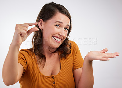 Buy stock photo Portrait, smile or woman with small hand palm space in studio for scale, comparison or measurement on white background. Unsure, face or model guess with finger gesture for emoji, doubt or mockup size
