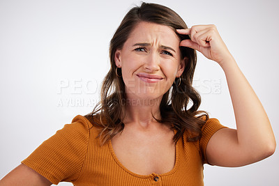 Buy stock photo Portrait, confused and frustrated woman with small hand sign in studio for scale, comparison or measurement on white background. Annoyed, face and angry model with tiny brain gesture, size or insult