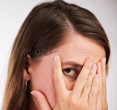 Buy stock photo Scary, face and woman with hands to cover or hide from surprise fail in portrait on studio background. Girl, worry and afraid of mistake, risk or watch movie with anxiety and protection of secret