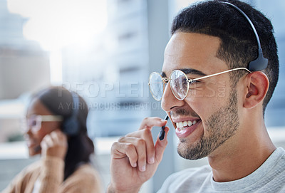 Buy stock photo Shot of male and female colleagues working together in their office at a call center