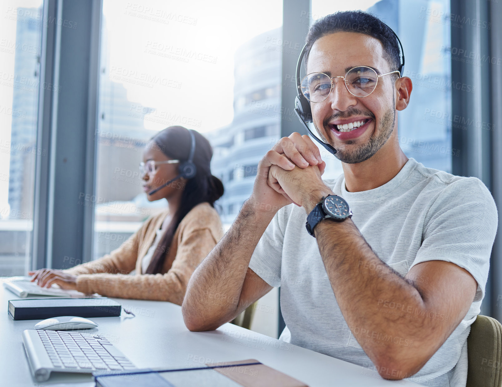 Buy stock photo Shot of male and female colleagues working together in their office at a call center