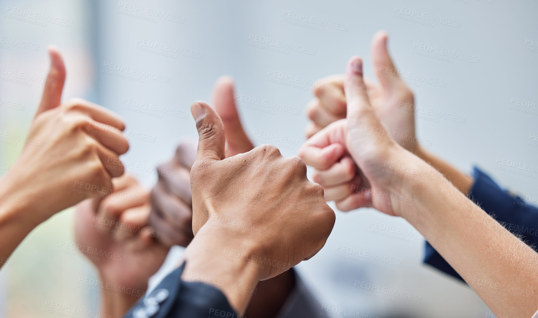 Buy stock photo Shot of  a group of coworkers with their arms raised in the thumbs up gesture