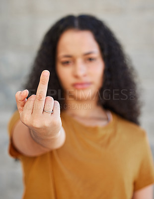 Buy stock photo Cropped shot of a young woman showing middle finger while standing outside