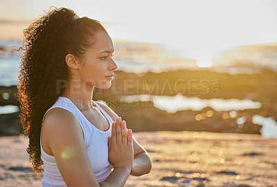 Buy stock photo Cropped shot of an attractive young woman meditating on the beach