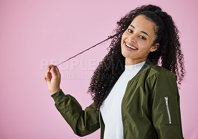 Buy stock photo Shot of an attractive young woman standing alone against a pink background in the studio
