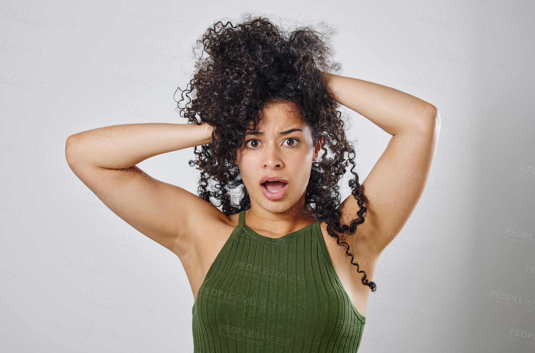 Buy stock photo Studio shot of a woman with messy hair posing against a grey background