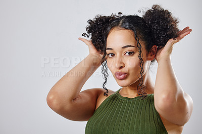 Buy stock photo Shot of a woman with two buns posing against a grey background