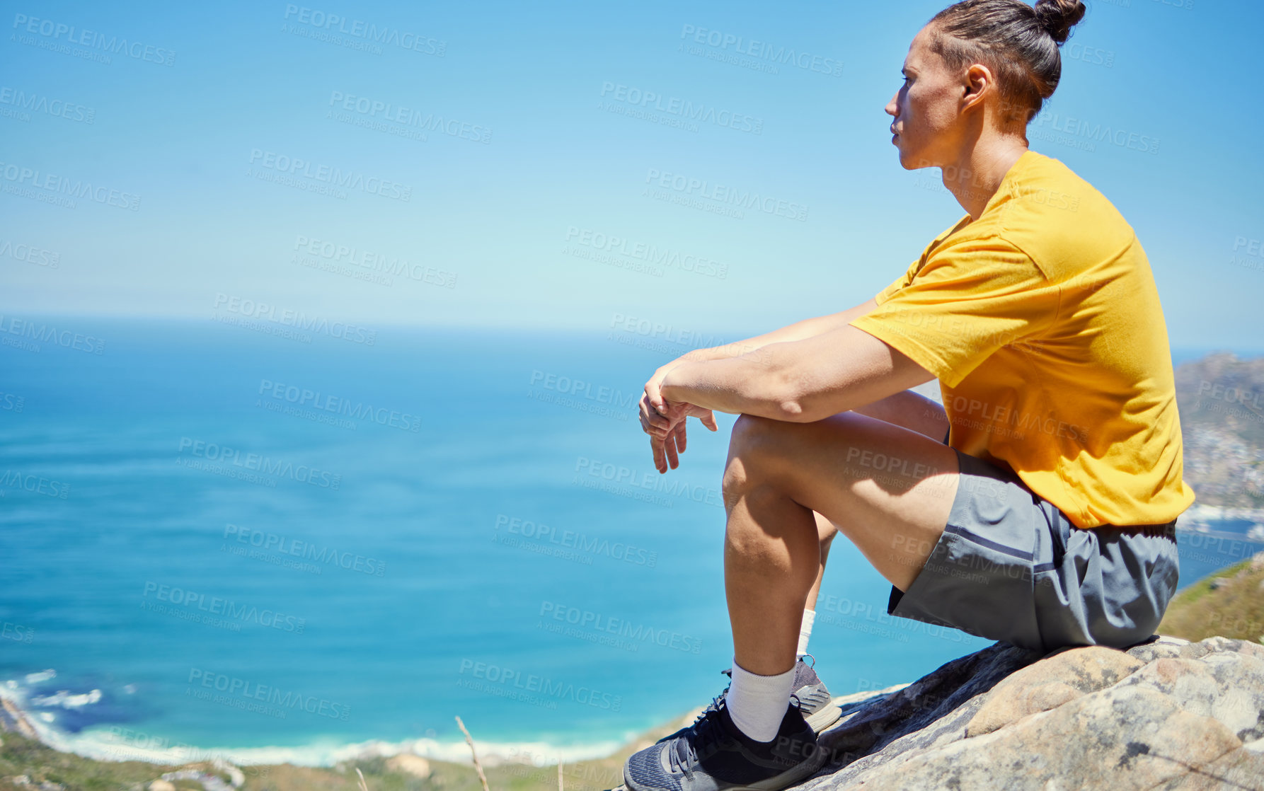 Buy stock photo Man, hiking and rest on mountain with ocean, ideas or vision with mockup space on blue sky background. Person, relax and memory with peace on rocks by sea, thinking and nature for trekking adventure