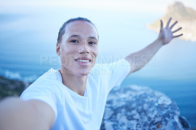 Buy stock photo Cropped portrait of a handsome young man taking selfies during his morning hike through the mountains