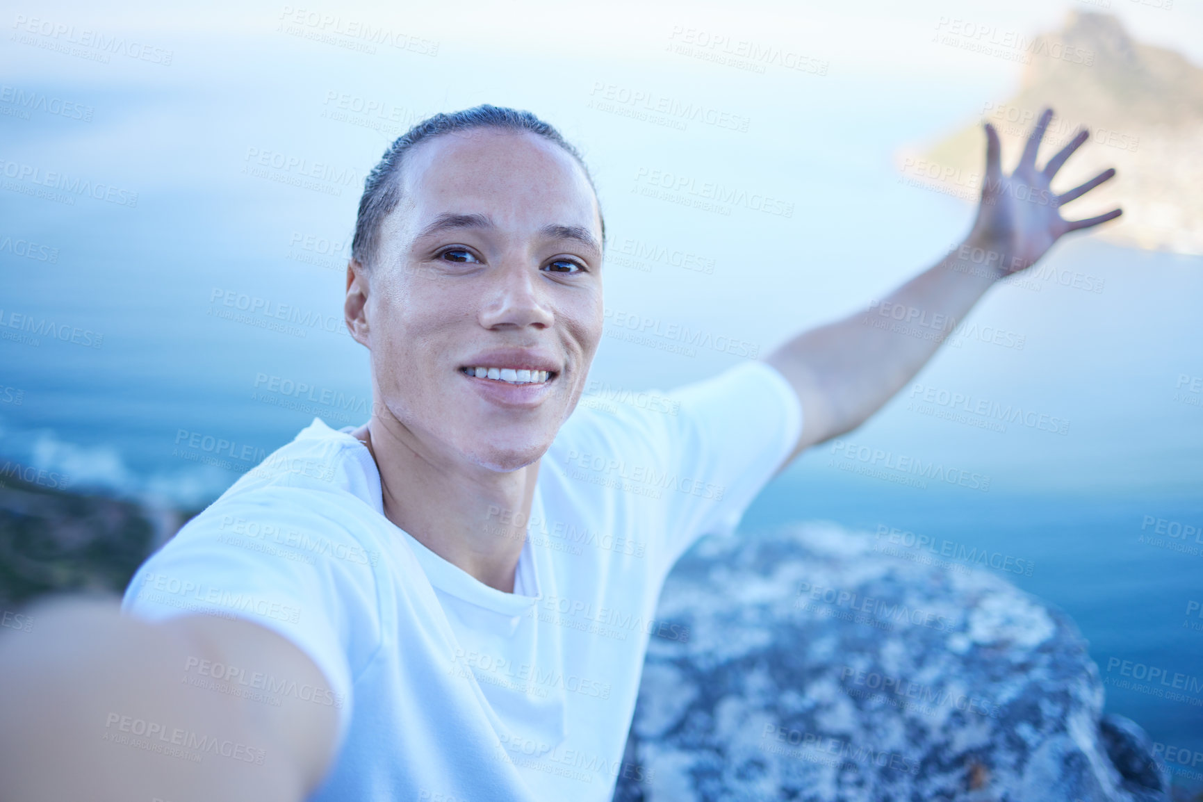 Buy stock photo Cropped portrait of a handsome young man taking selfies during his morning hike through the mountains