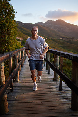 Buy stock photo Running, exercise and man in nature in morning for fitness, marathon training and workout. Sports, sunrise and male runner on footbridge, cardio and outdoors for performance, wellness and health