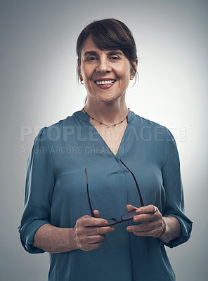 Buy stock photo Studio portrait of a senior woman standing against a grey background