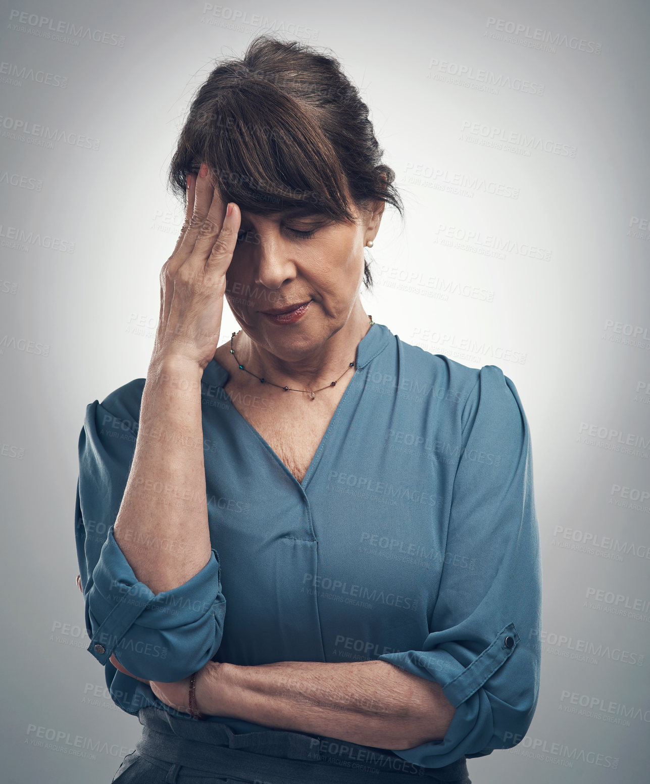 Buy stock photo Studio shot of a senior woman looking stressed out against a grey background