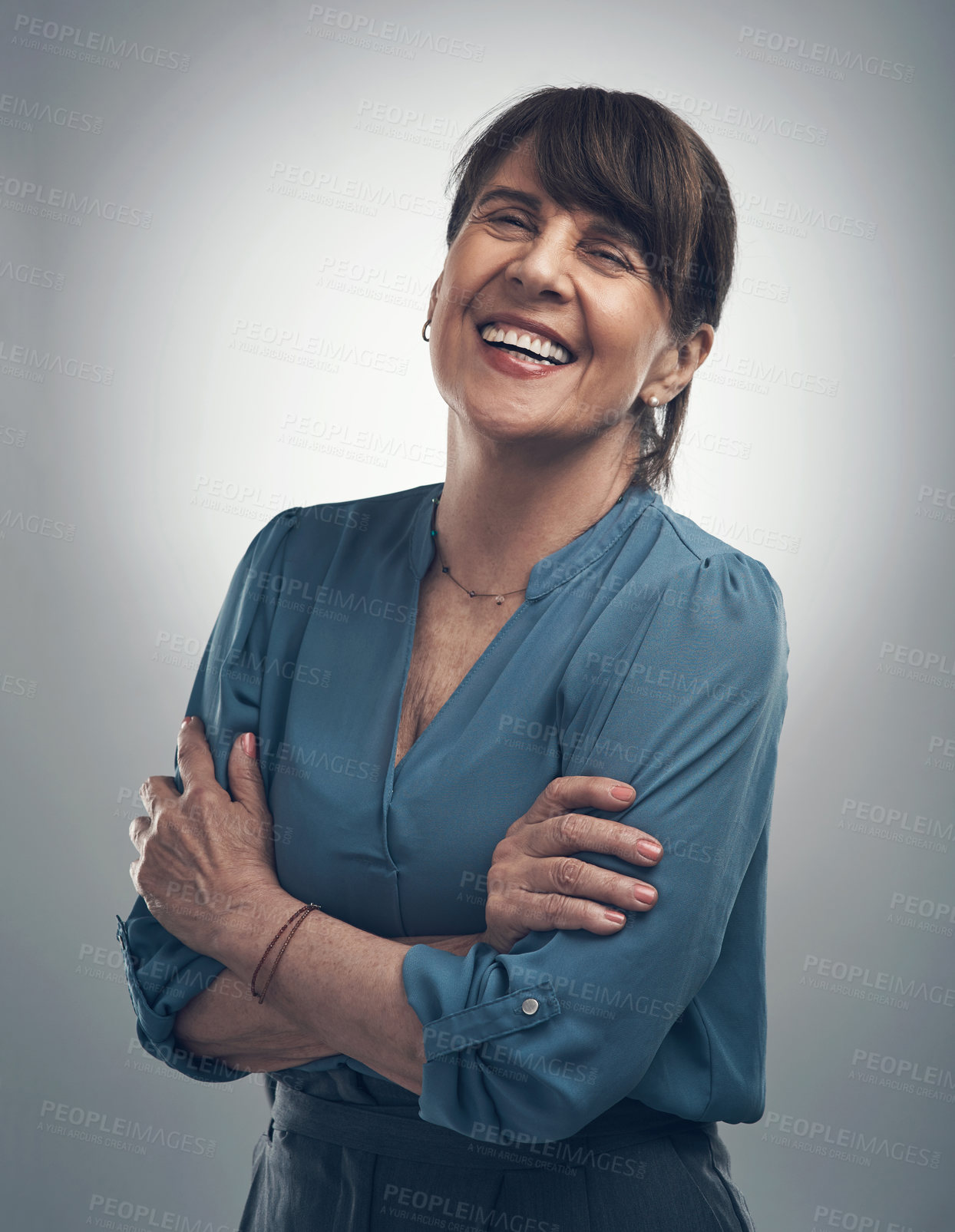 Buy stock photo Studio portrait of a senior woman standing with her arms crossed against a grey background