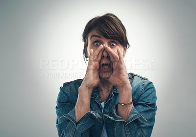 Buy stock photo Studio portrait of a senior woman shouting against a grey background