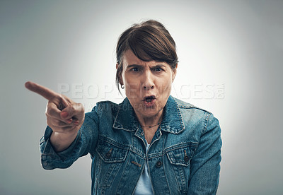 Buy stock photo Studio portrait of a senior woman yelling against a grey background