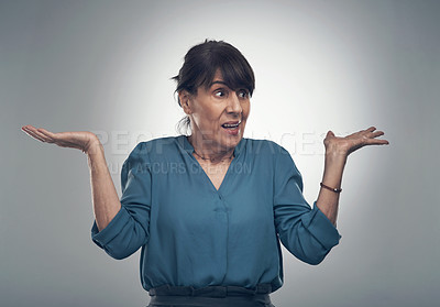 Buy stock photo Studio shot of a senior woman shrugging against a grey background