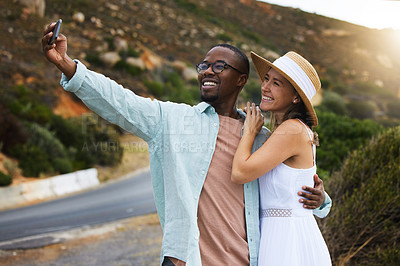 Buy stock photo Road trip, interracial couple and hug for selfie in nature, travel or countryside for vacation in Brazil. Love, people and happy using phone for picture for holiday, journey and smile together