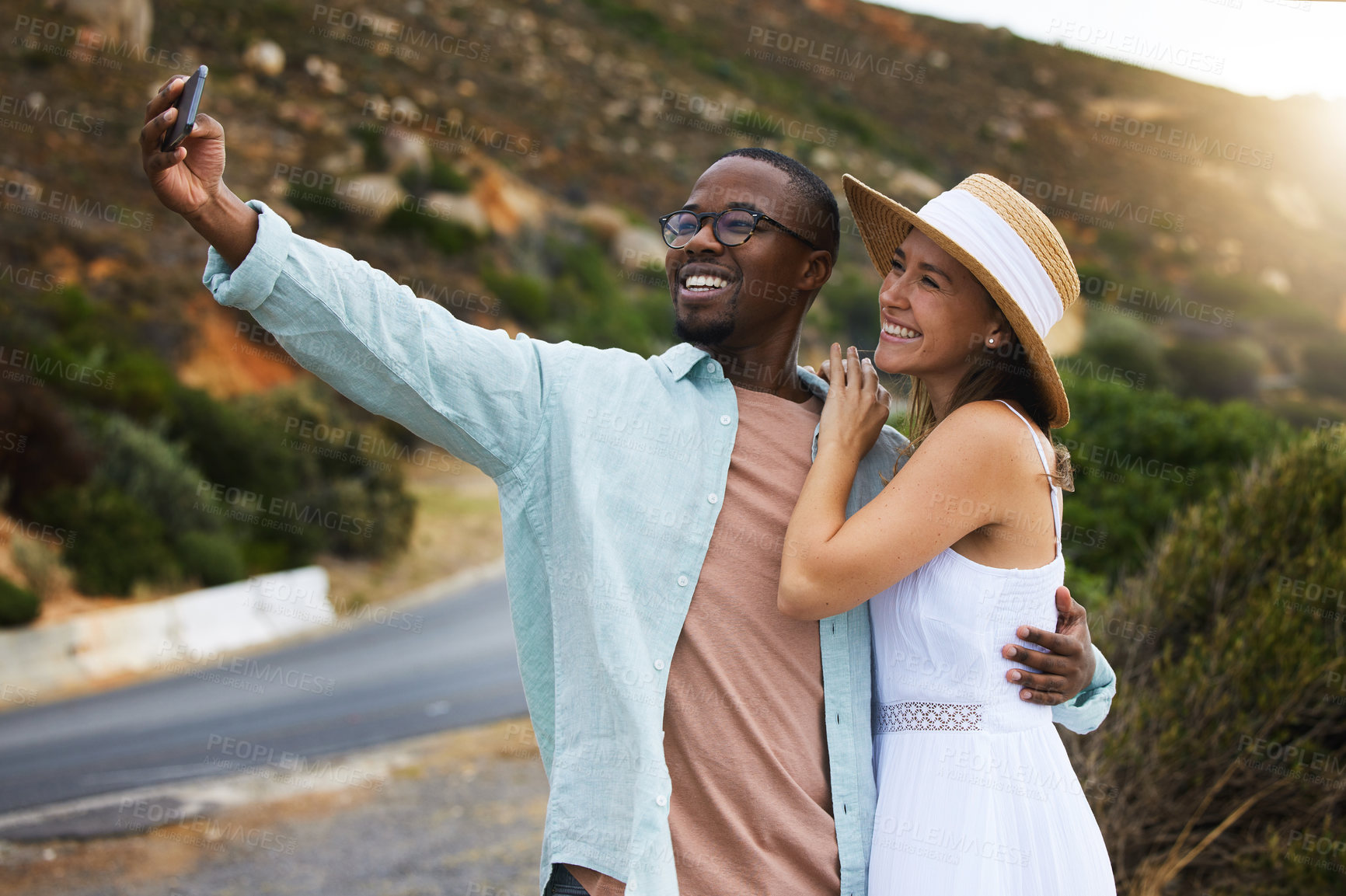 Buy stock photo Road trip, interracial couple and hug for selfie in nature, travel or countryside for vacation in Brazil. Love, people and happy using phone for picture for holiday, journey and smile together