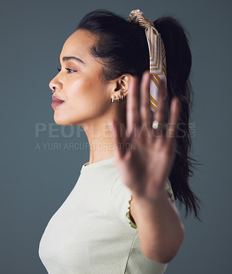 Buy stock photo Woman, fashion and stop on profile in studio on grey background in casual, style and cool. Female person, ban sign and wait with hand gesture, warning and patient or reject with limits and defense