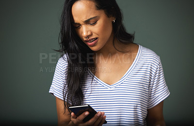 Buy stock photo Confused, smartphone and woman in studio for scam, phishing or fake news on green background. Communication, annoyed and person on mobile phone for internet problem, spam email or negative text