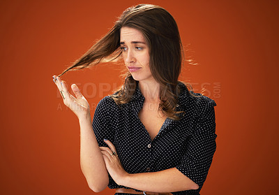 Buy stock photo Studio, unhappy and woman with hair, damage and hairloss with split ends, dry and treatment for haircare. Red background, mockup and girl with texture, entangled and matted with cosmetics in salon
