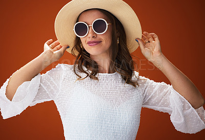 Buy stock photo Studio shot of a stylish young woman posing against a brown background