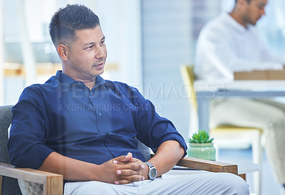Buy stock photo Shot of a businessman sitting in a modern office