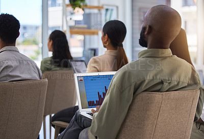 Buy stock photo Shot of a unrecognizable male using his laptop during a seminar in a modern office