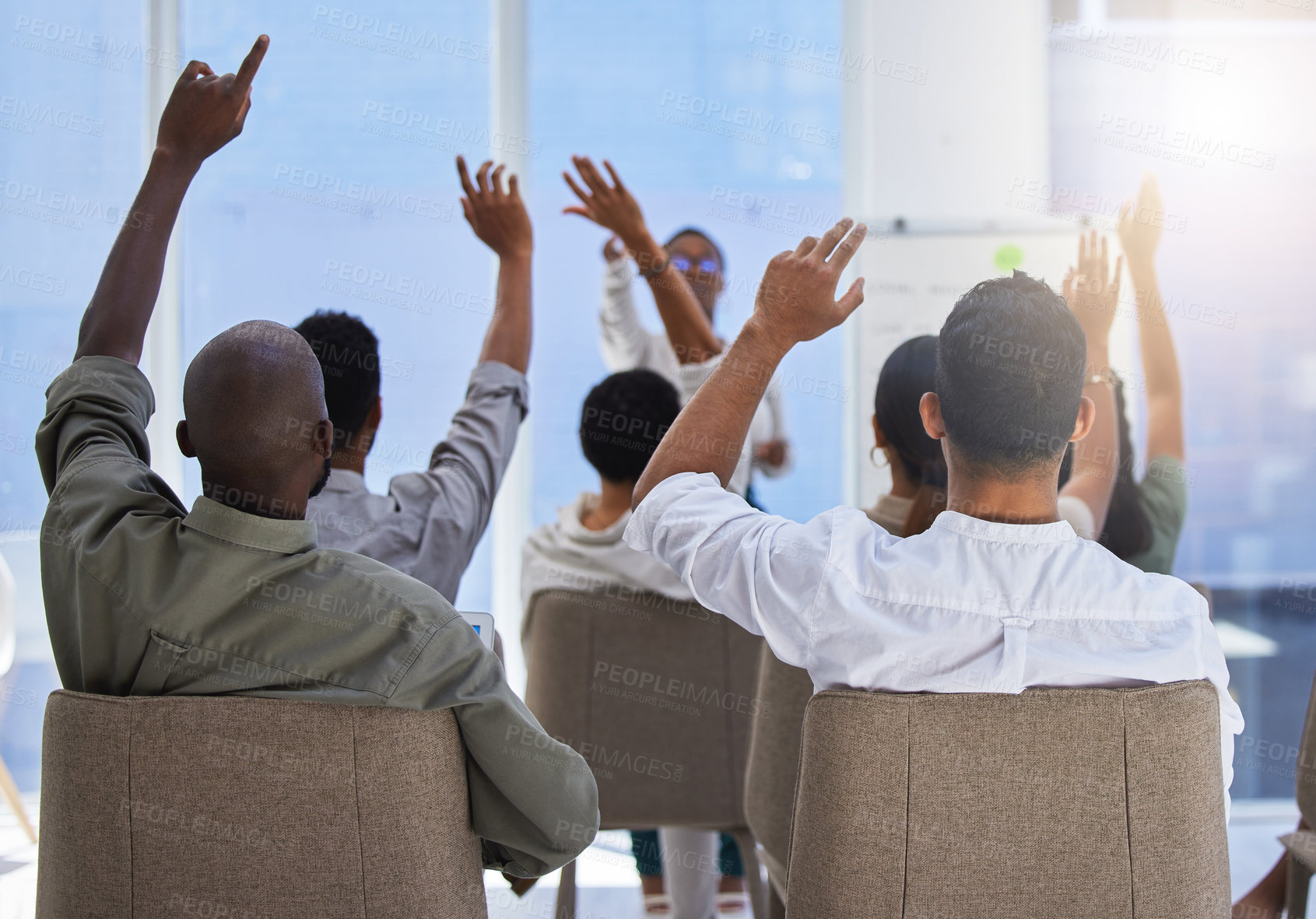 Buy stock photo Shot of a unrecognizable group of people lifting their hands at a work seminar in a modern office