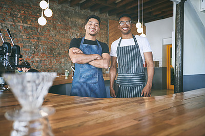Buy stock photo Shot of two confident young men working in a cafe