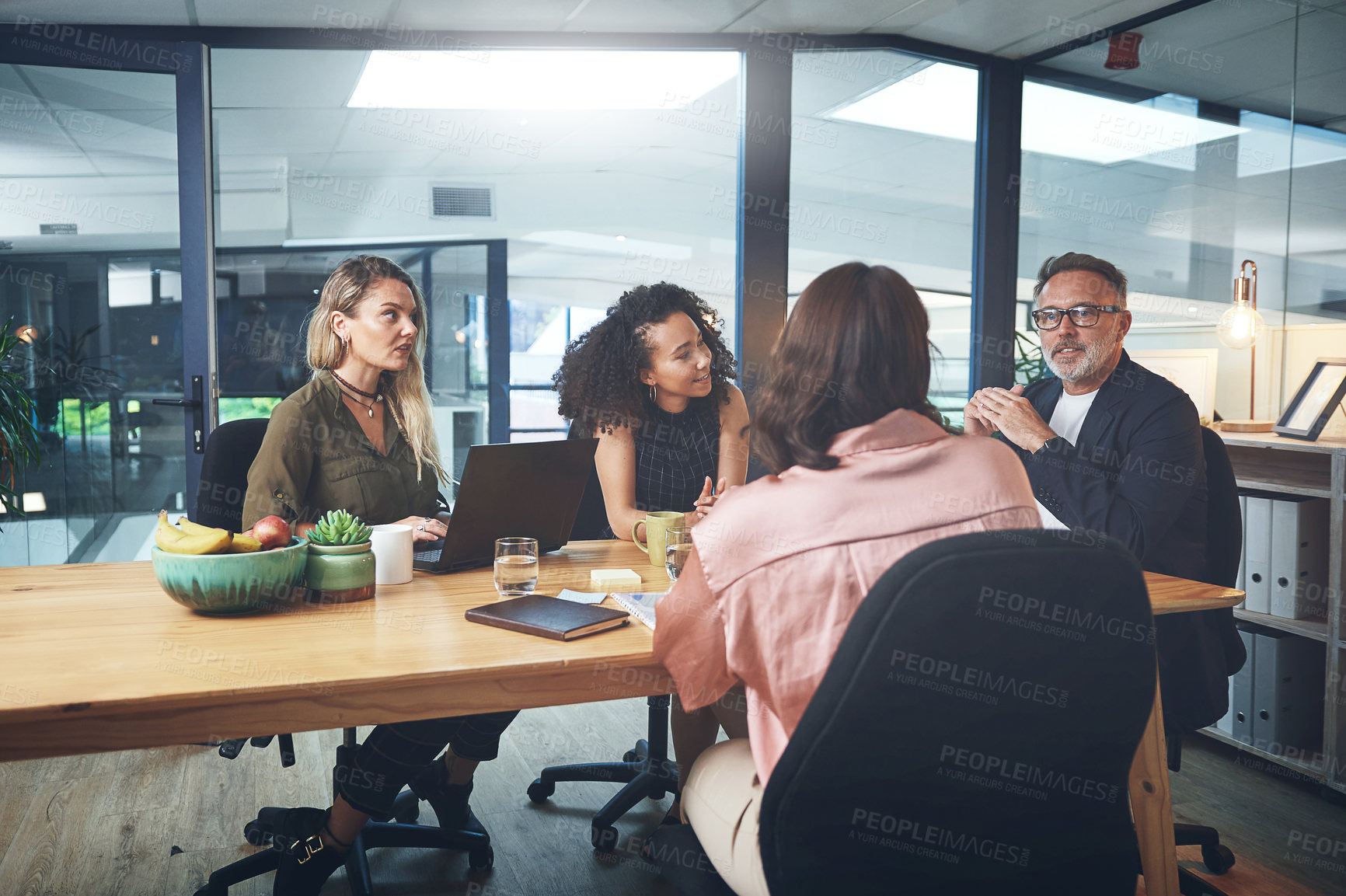 Buy stock photo Shot of a group of businesspeople having a meeting in the boardroom of a modern office