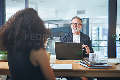 Buy stock photo Shot of a mature businessman having a meeting with his coworker in the boardroom of a modern office