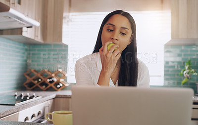 Buy stock photo Kitchen, apple and woman with laptop for remote work, breakfast and coffee for online career. Eating fruit, reading and freelancer girl in home with computer for web project, research and nutrition.