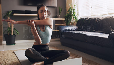 Buy stock photo Stretching, Indian woman and laptop for online yoga on living floor for training, balance or healthy lifestyle. Arm, stretch and female person start fitness tutorial for pilates or meditation workout